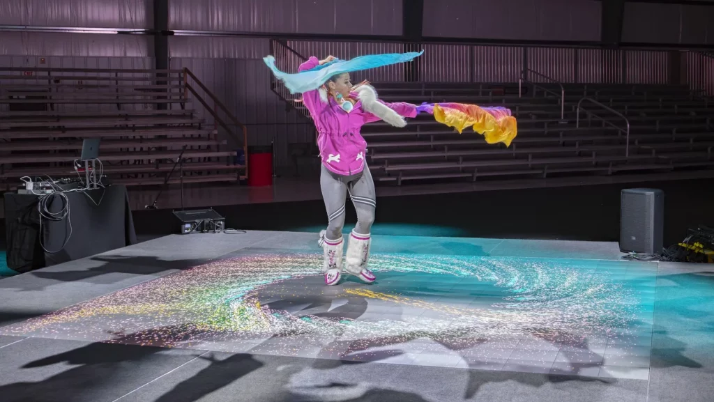 A dancer using the touch-capable LED flooring during her performance.