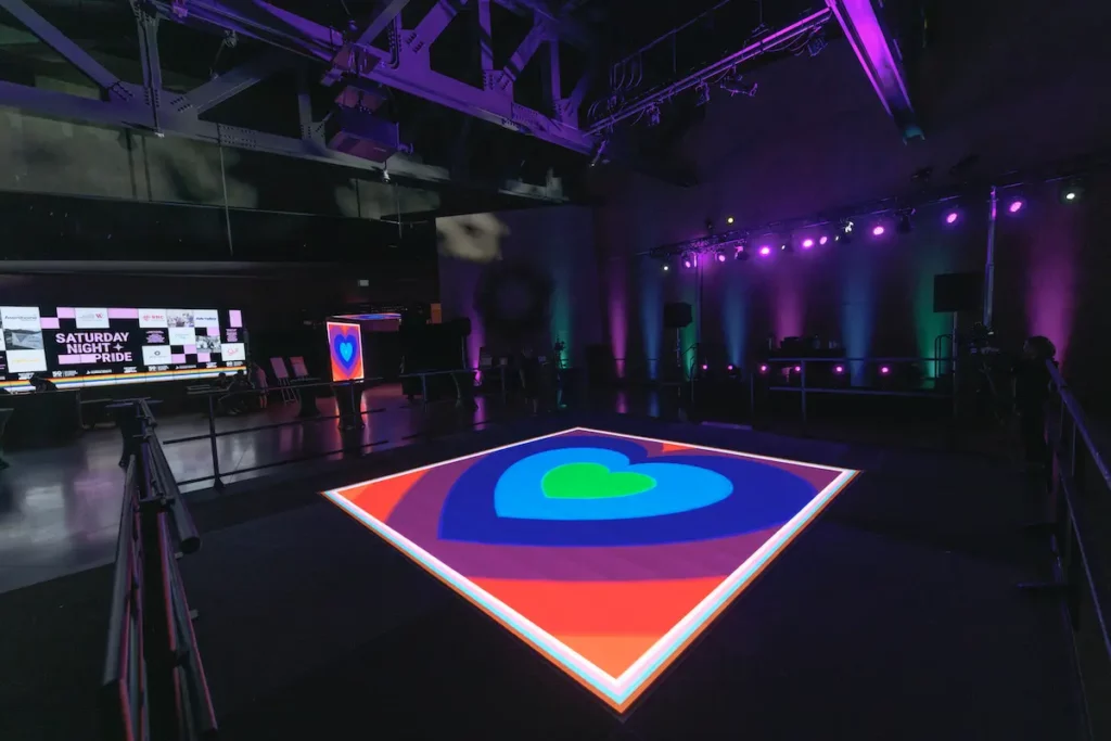 An LED floor with rainbow hearts on it
